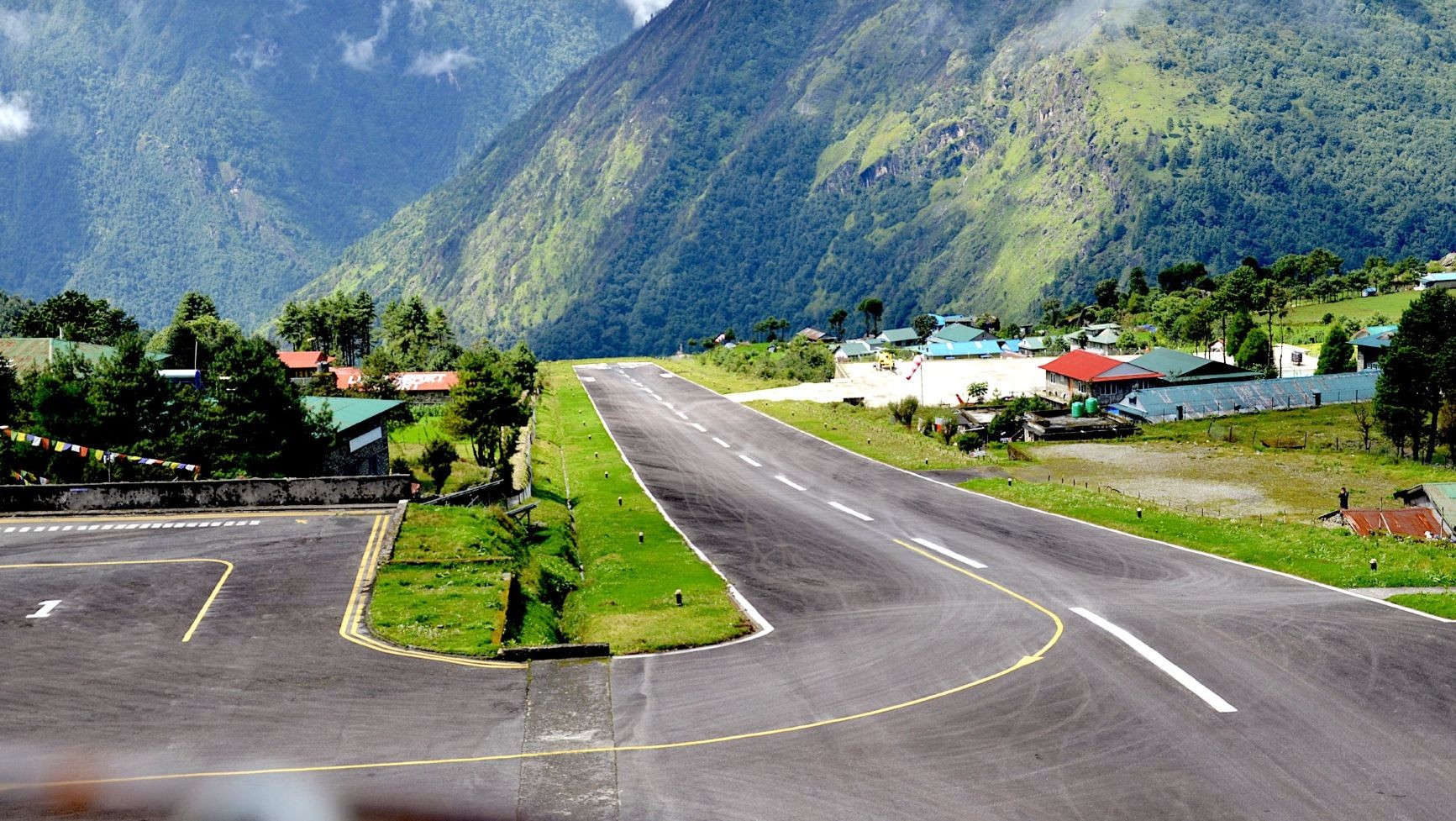 Lukla Airport under clear November skies, surrounded by Himalayan mountains and excellent visibility.