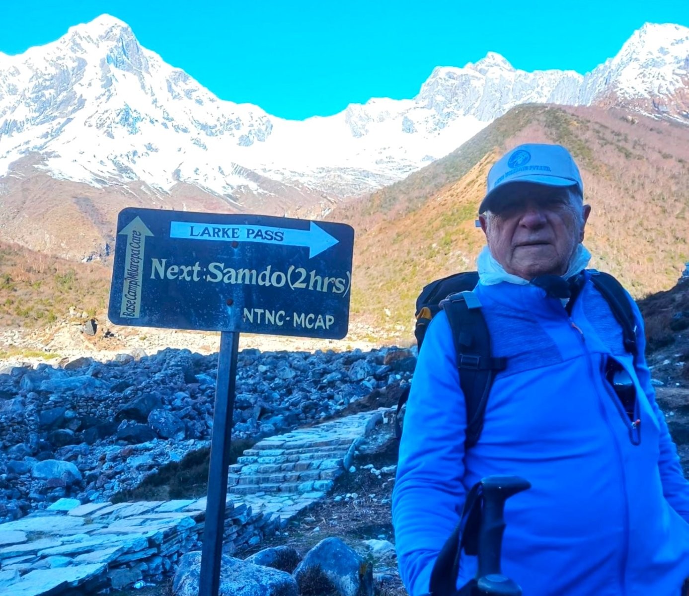Trekker walking on mountain path toward Larke Pass