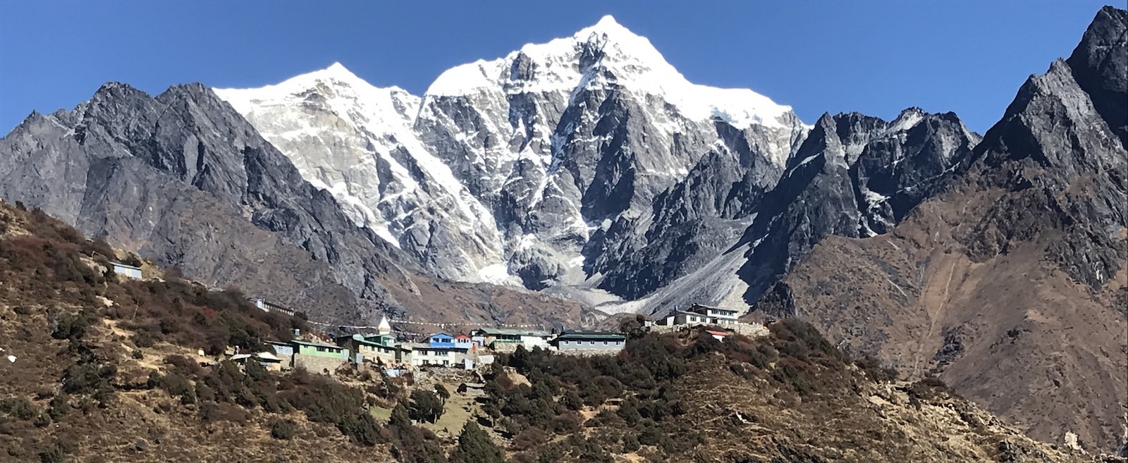 "Mong Danda viewpoint on the Everest Base Camp and Gokyo Lakes trekking route offering panoramic views of Ama Dablam, Thamserku, Kangtega, and the Himalayan mountains in Nepal."