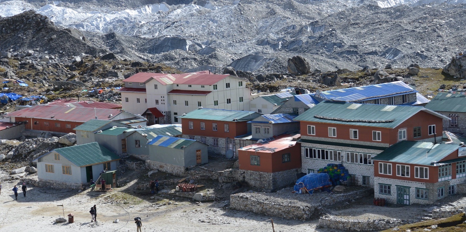 Lodges and teahouses at Gorak Shep surrounded by rocky glacial terrain beneath the Khumbu Glacier on the Everest Base Camp Trek.