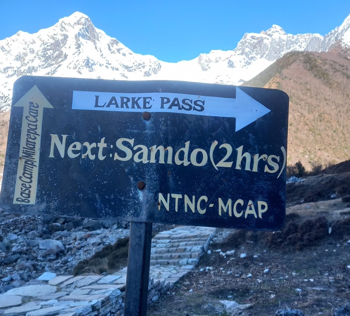 Trekkers walking on a dry, well-maintained mountain trail with stable rocky paths, alpine landscapes, and spectacular Himalayan views during the Manaslu Circuit Trek in October.