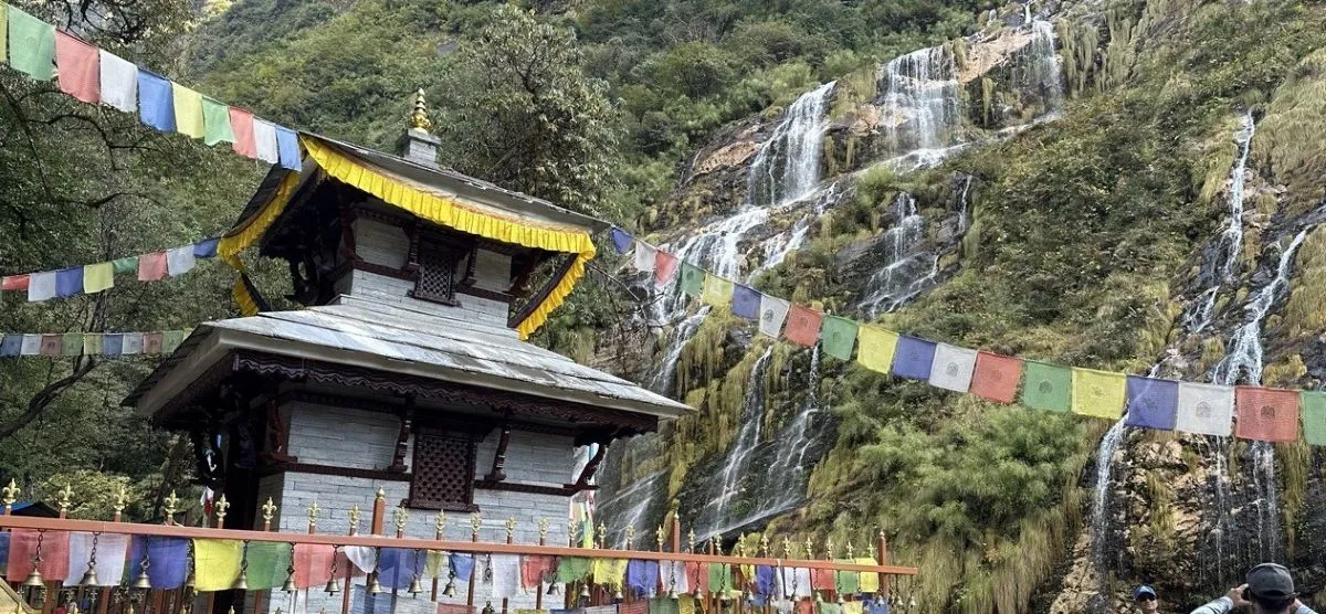 Baraha Temple on the Annapurna Base Camp Trek route, surrounded by cascading waterfalls, the Modi Khola gorge, lush forests, rocky cliffs, and serene Himalayan scenery.