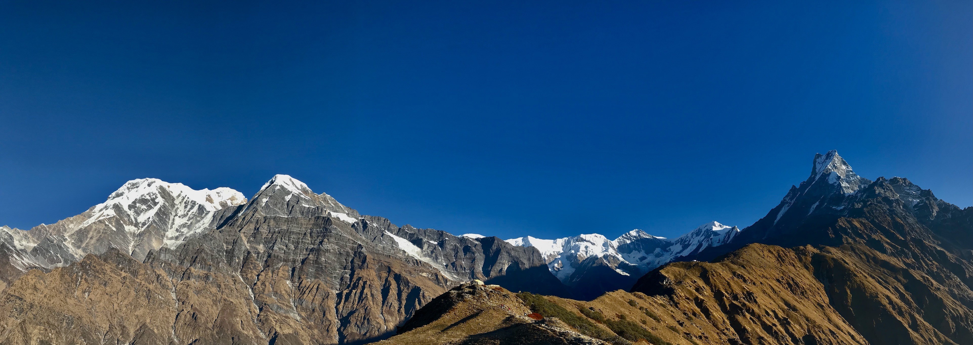 Panoramic Himalayan mountain views from the Mardi Himal Trek, featuring Machhapuchhre and surrounding snow-capped peaks.