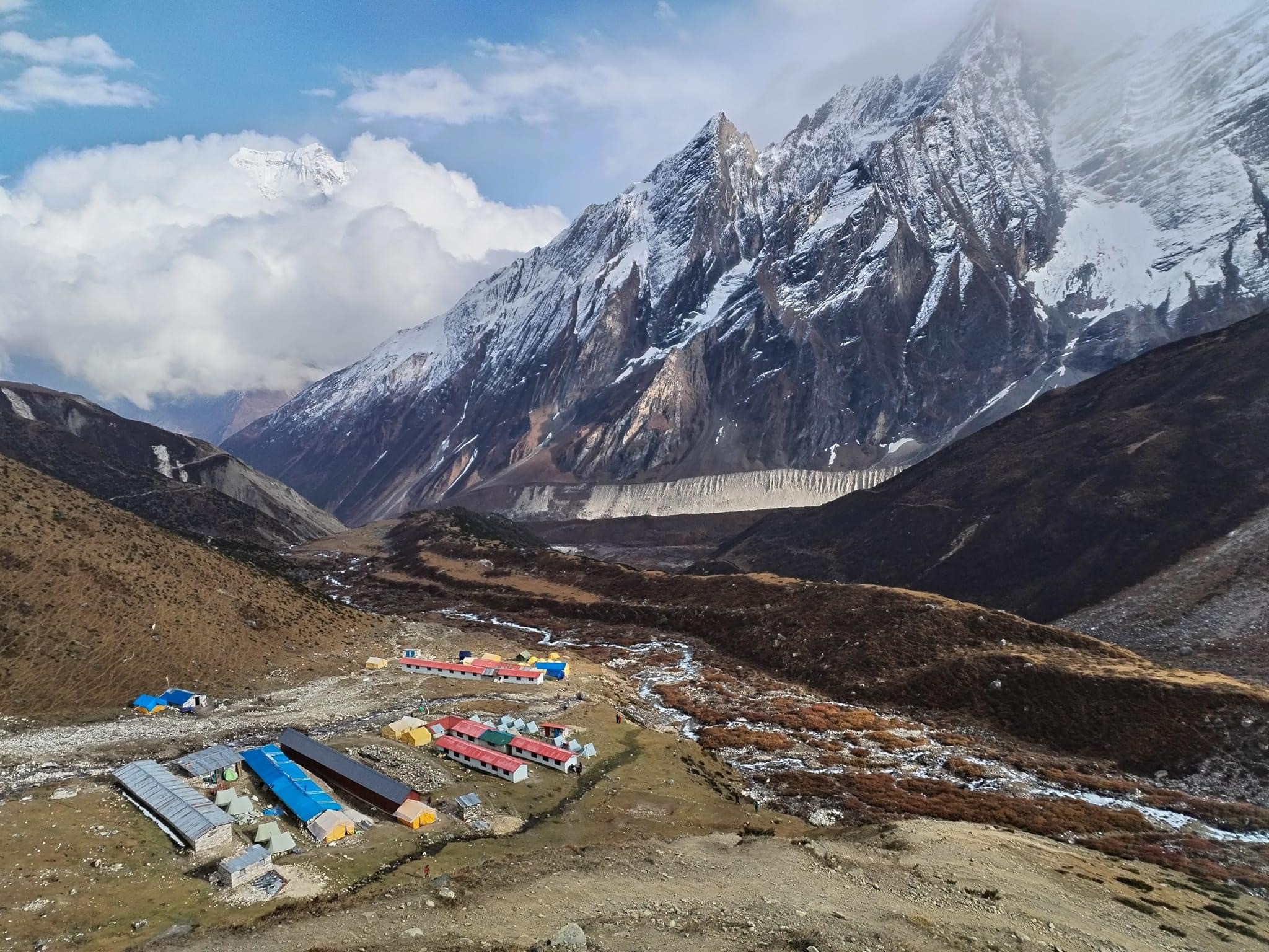 Mountain lodge at Dharamsala surrounded by cold alpine landscapes on the Manaslu Circuit Trek near Larke Pass, Nepal.