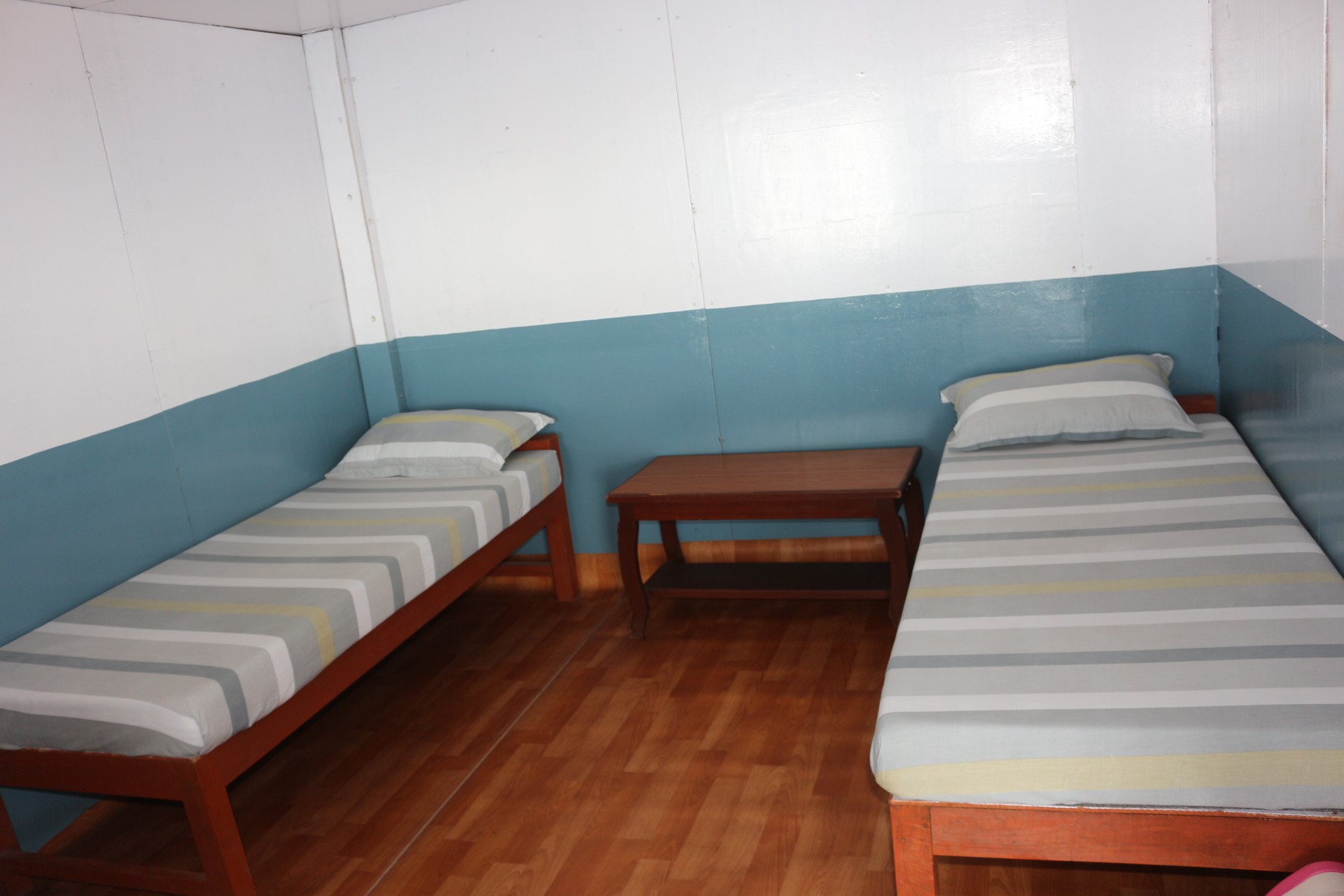 Teahouse lodge room in Nepal during Himalayan trek with basic bedding and thin walls in unheated accommodation
