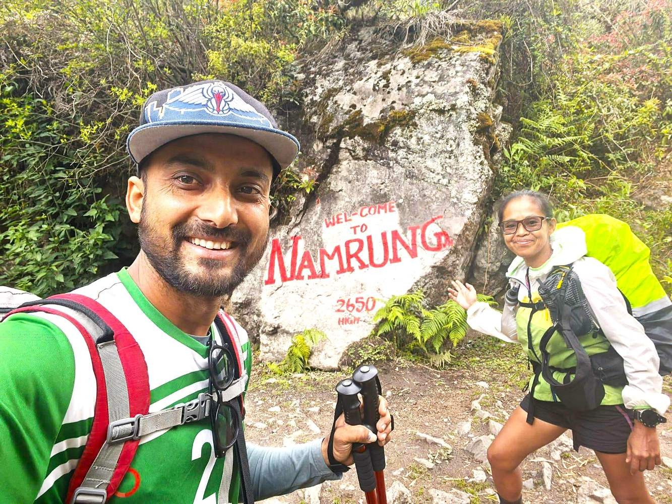 Guide and trekkers posing in Namrung village on the Manaslu Circuit Trek, Nepal.