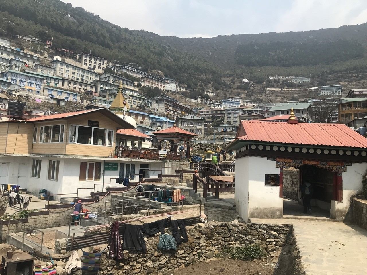 Namche Bazaar, the vibrant Sherpa town in the Everest region, featuring colorful lodges, mountain shops, traditional houses, and spectacular Himalayan scenery.