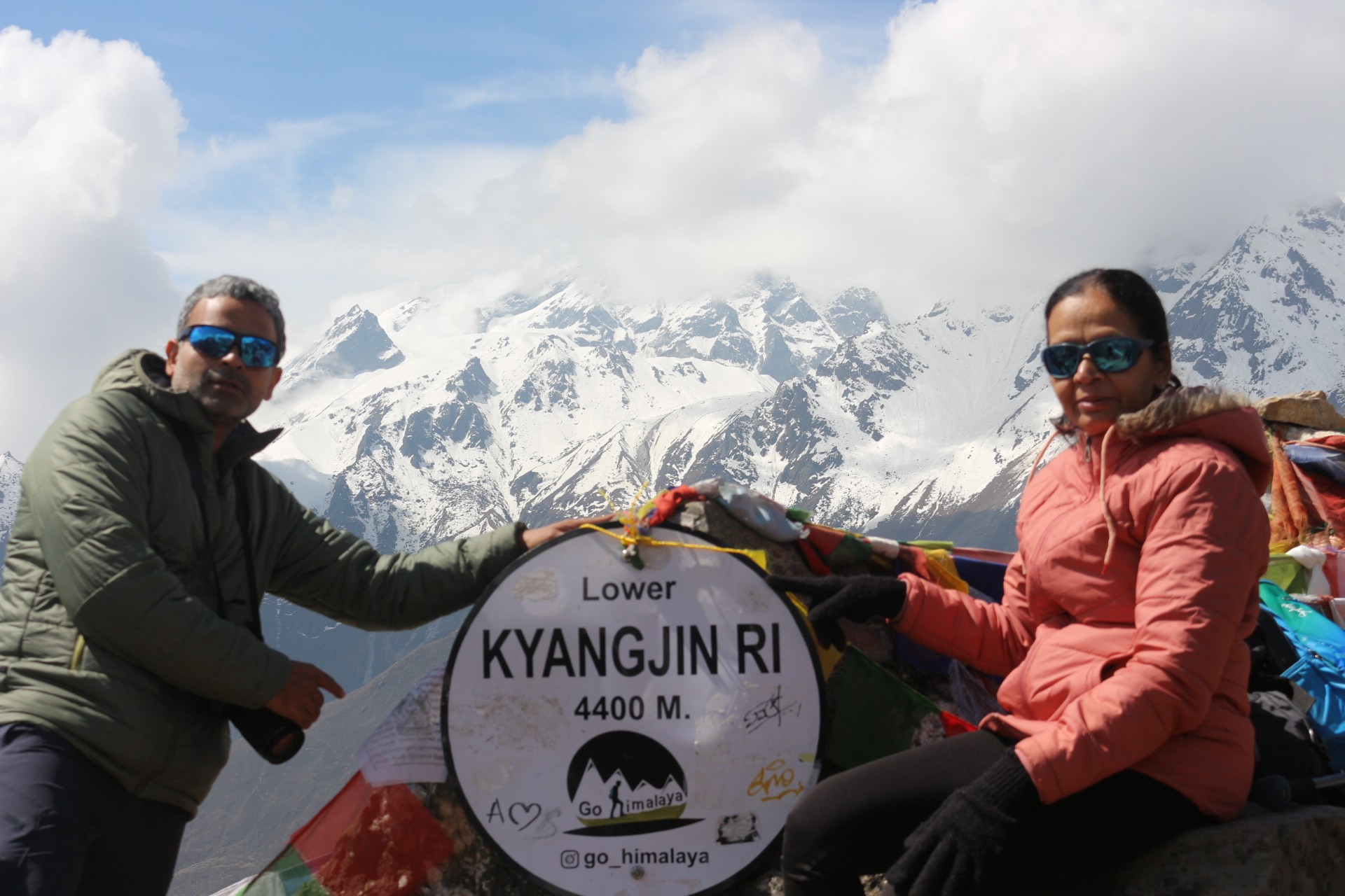 Trekkers standing on the summit of Kyanjin Ri, enjoying panoramic views of snow-capped Himalayan peaks, glaciers, and the Langtang Valley below.
