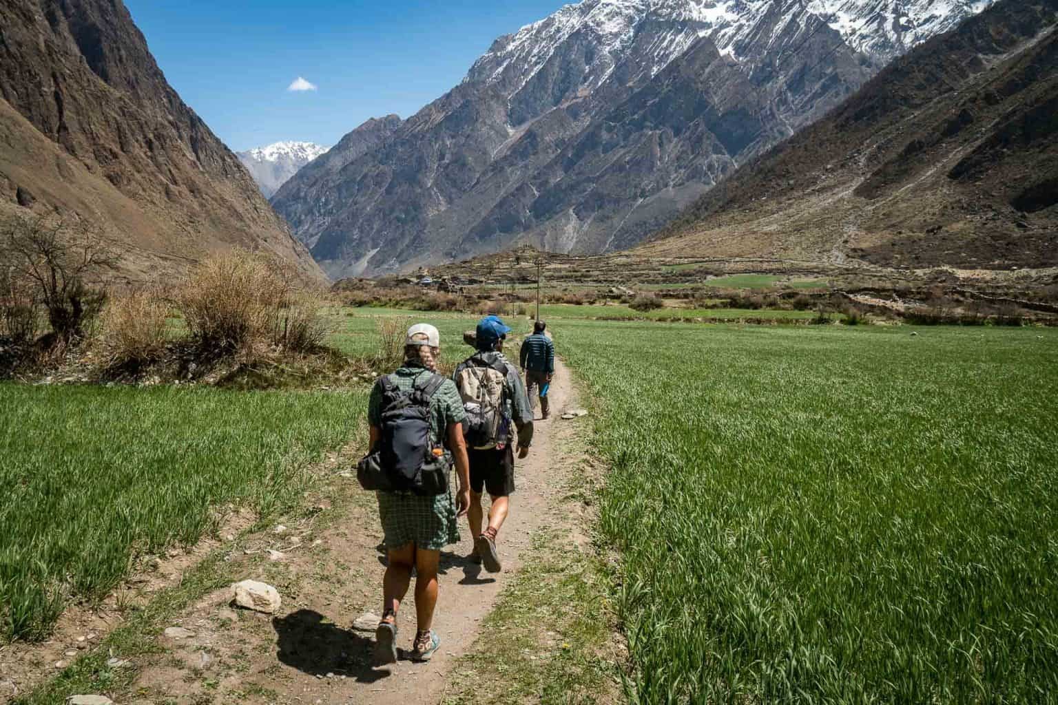 Beautiful farmland and green mountain landscape in Tsum Valley, Nepal, surrounded by traditional villages and Himalayan scenery.