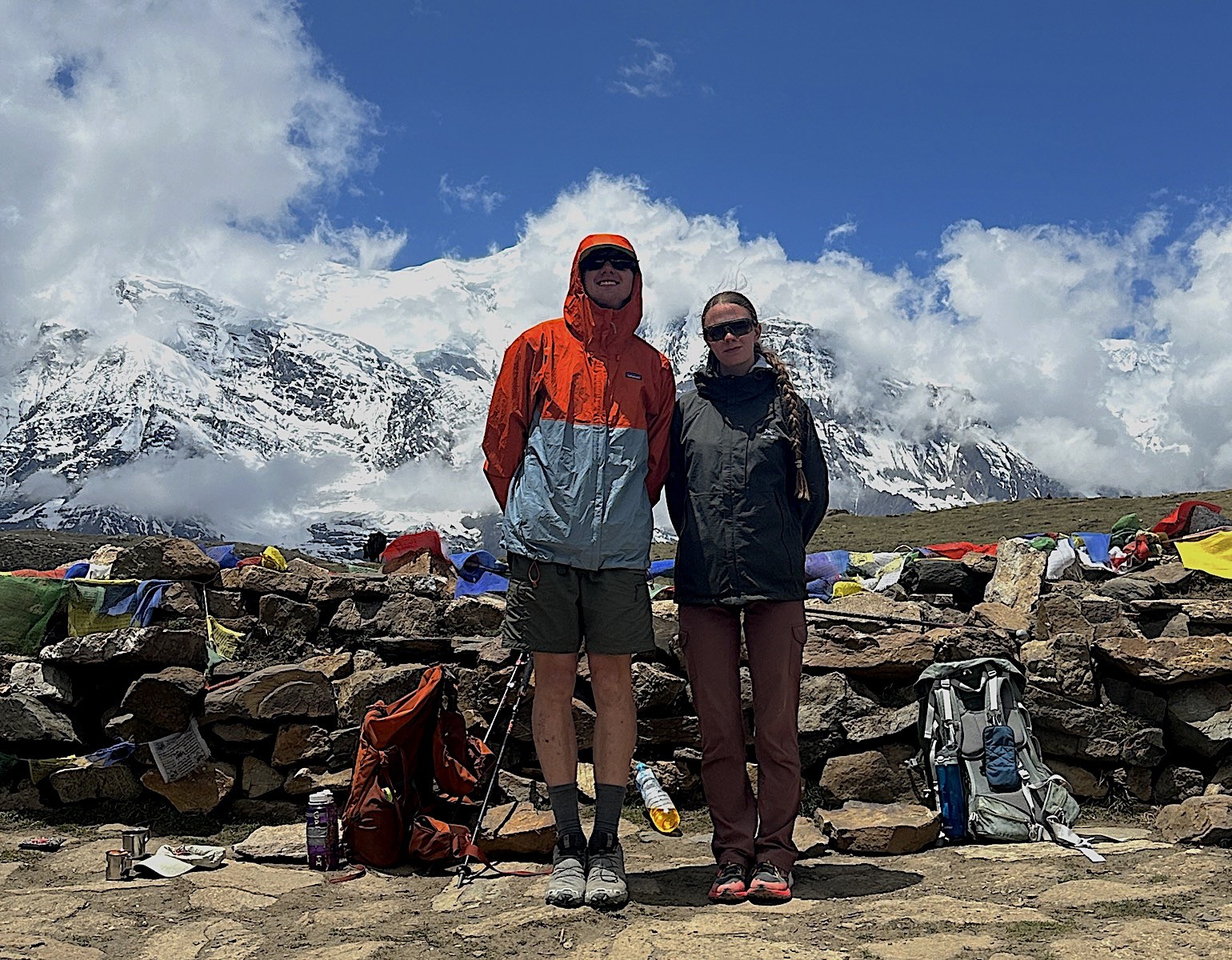 Trekker standing on stable mountain trail during October trekking season in Nepal with clear weather and solid footing”