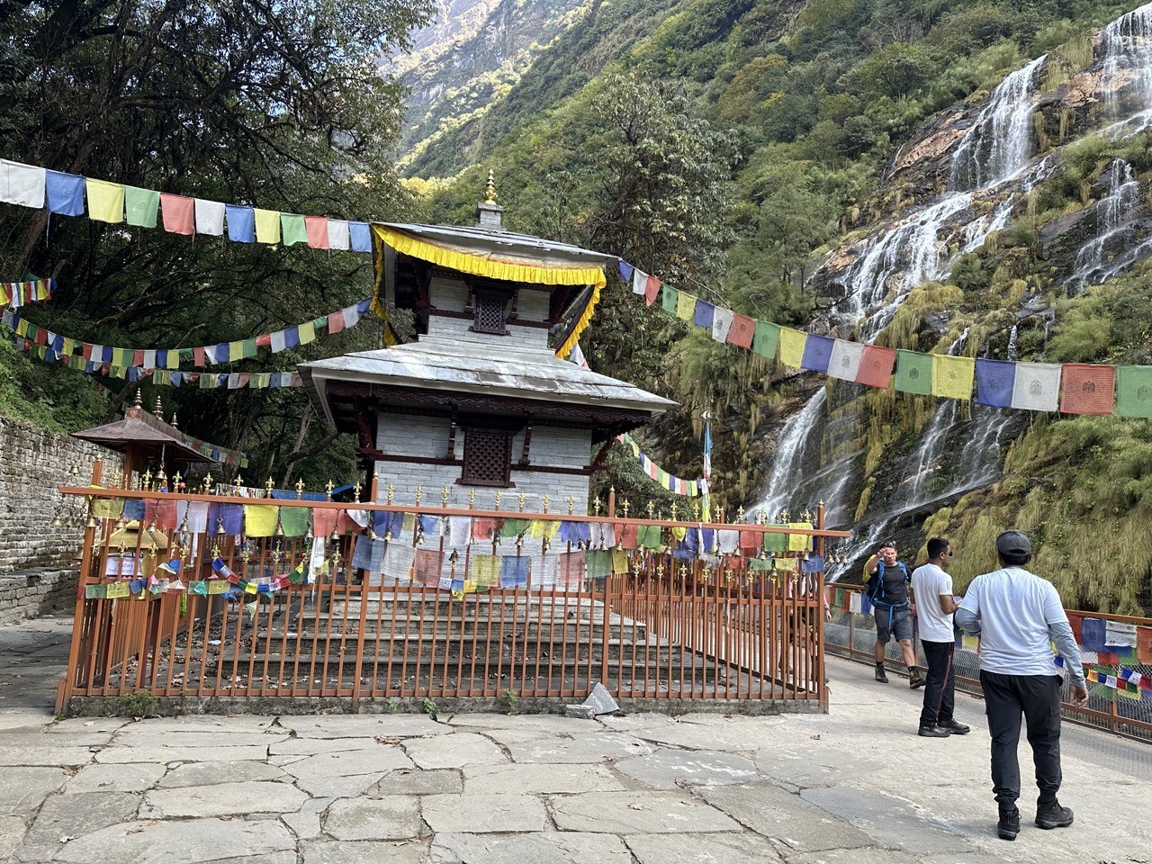Baraha Temple along the Annapurna Base Camp trekking route, surrounded by lush forests, traditional stone structures, prayer offerings, and peaceful natural scenery.