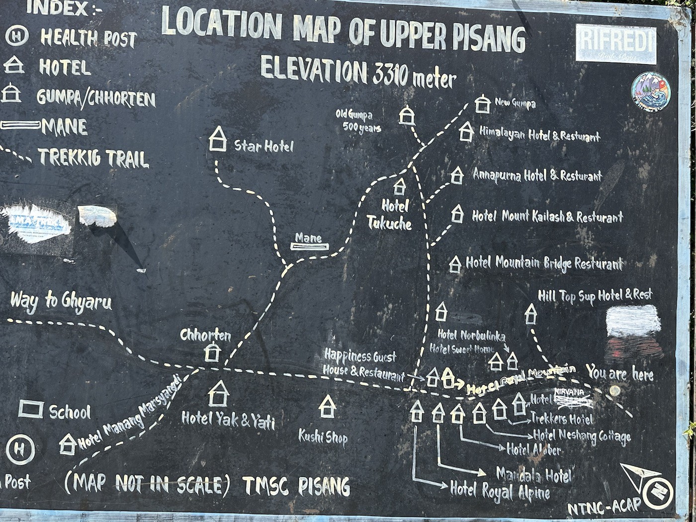 Detailed map of Pisang Village on the Annapurna Circuit Trek, showing Upper Pisang, Lower Pisang, trekking trails, Marshyangdi River, nearby monasteries, suspension bridges, and surrounding Himalayan peaks including Annapurna II, Annapurna IV, and Pisang Peak.