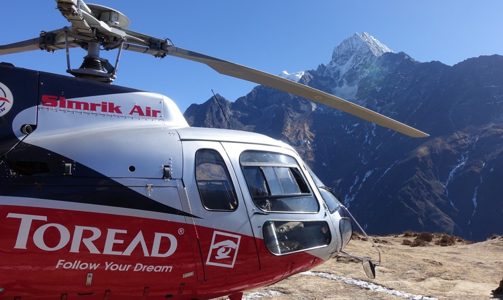 Helicopter flying over mountain landscape