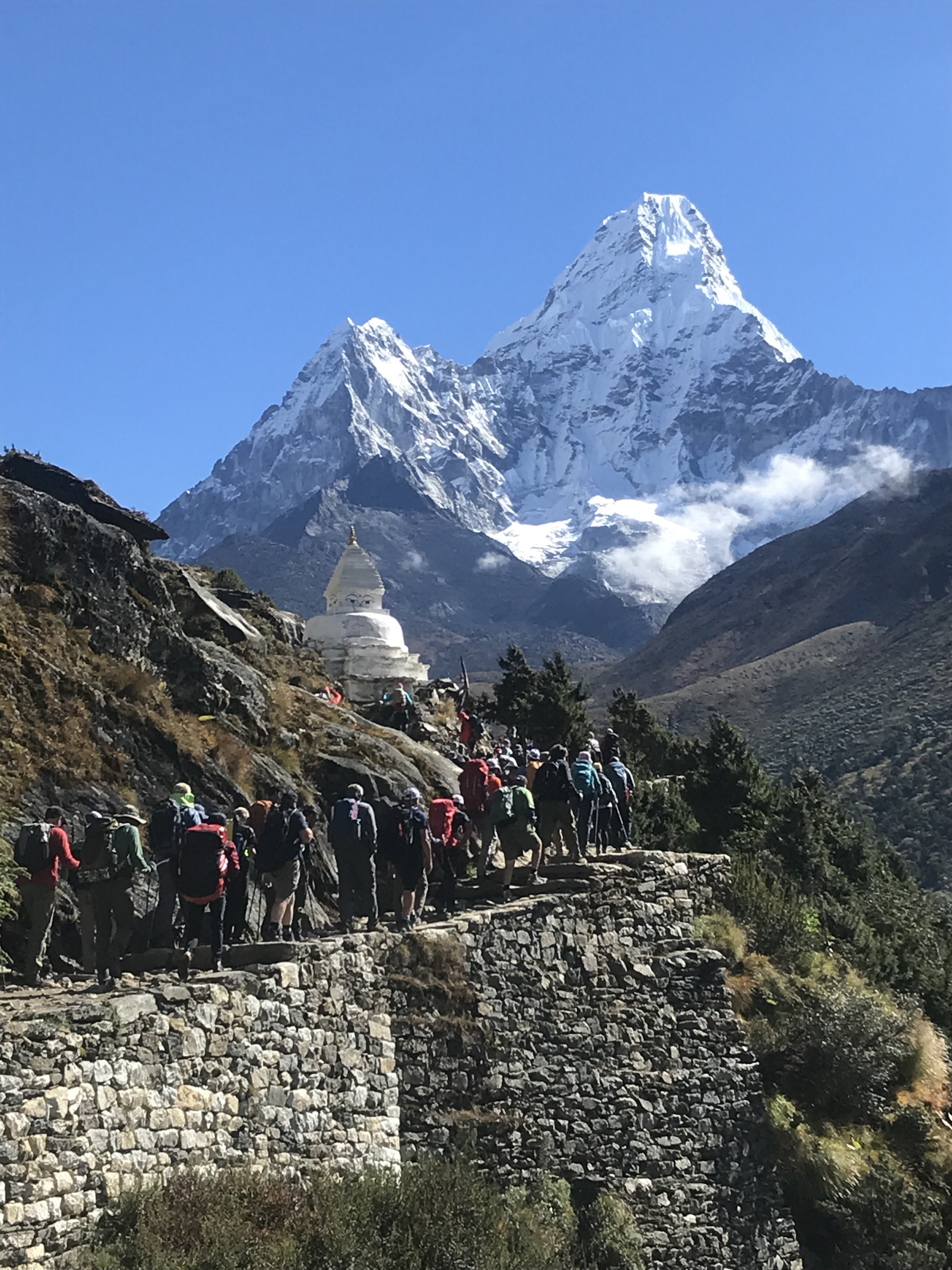 Trekkers crossing alpine terrain with Ama Dablam behind-Into Everest’s heart