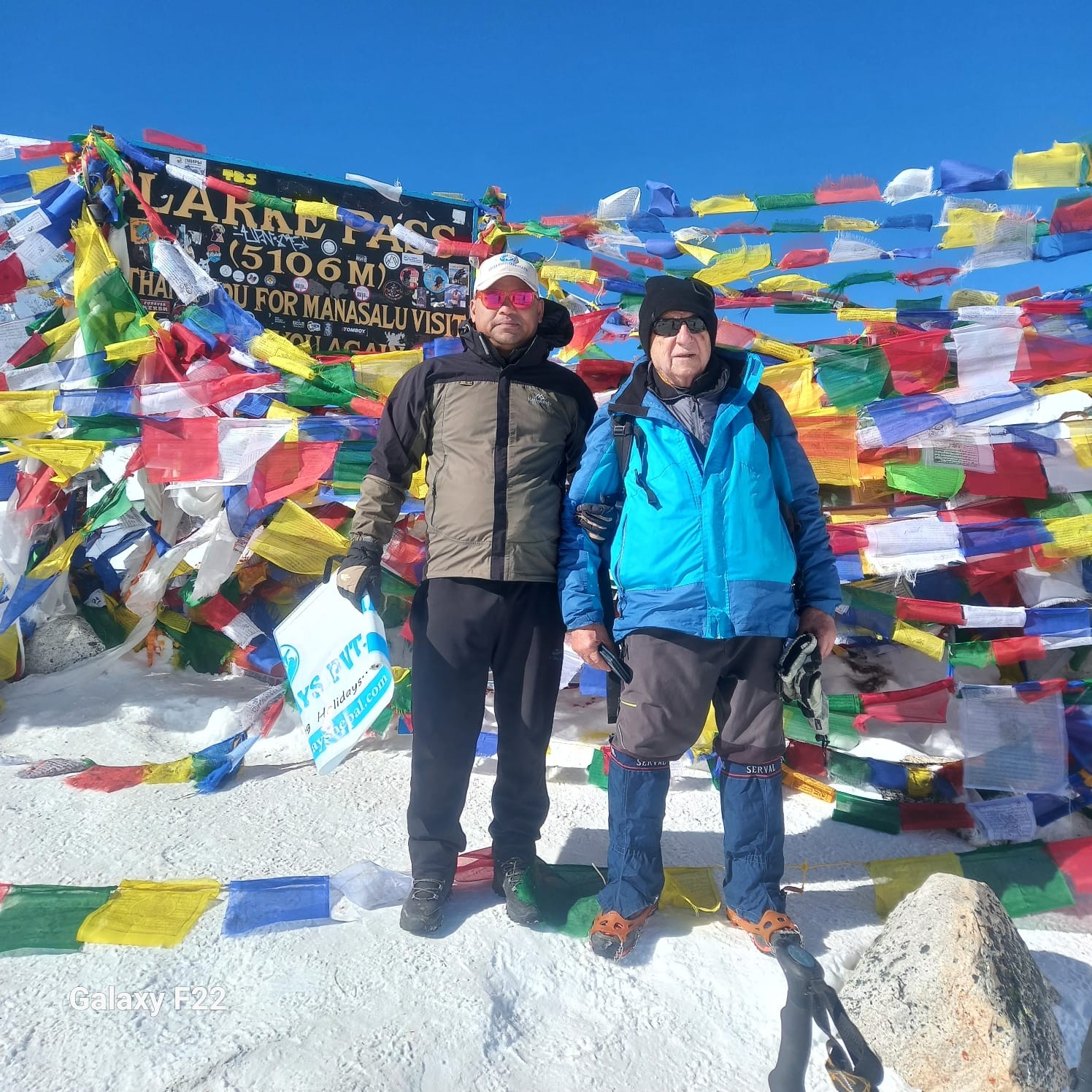 Guest standing at Larke Pass with snowy mountains