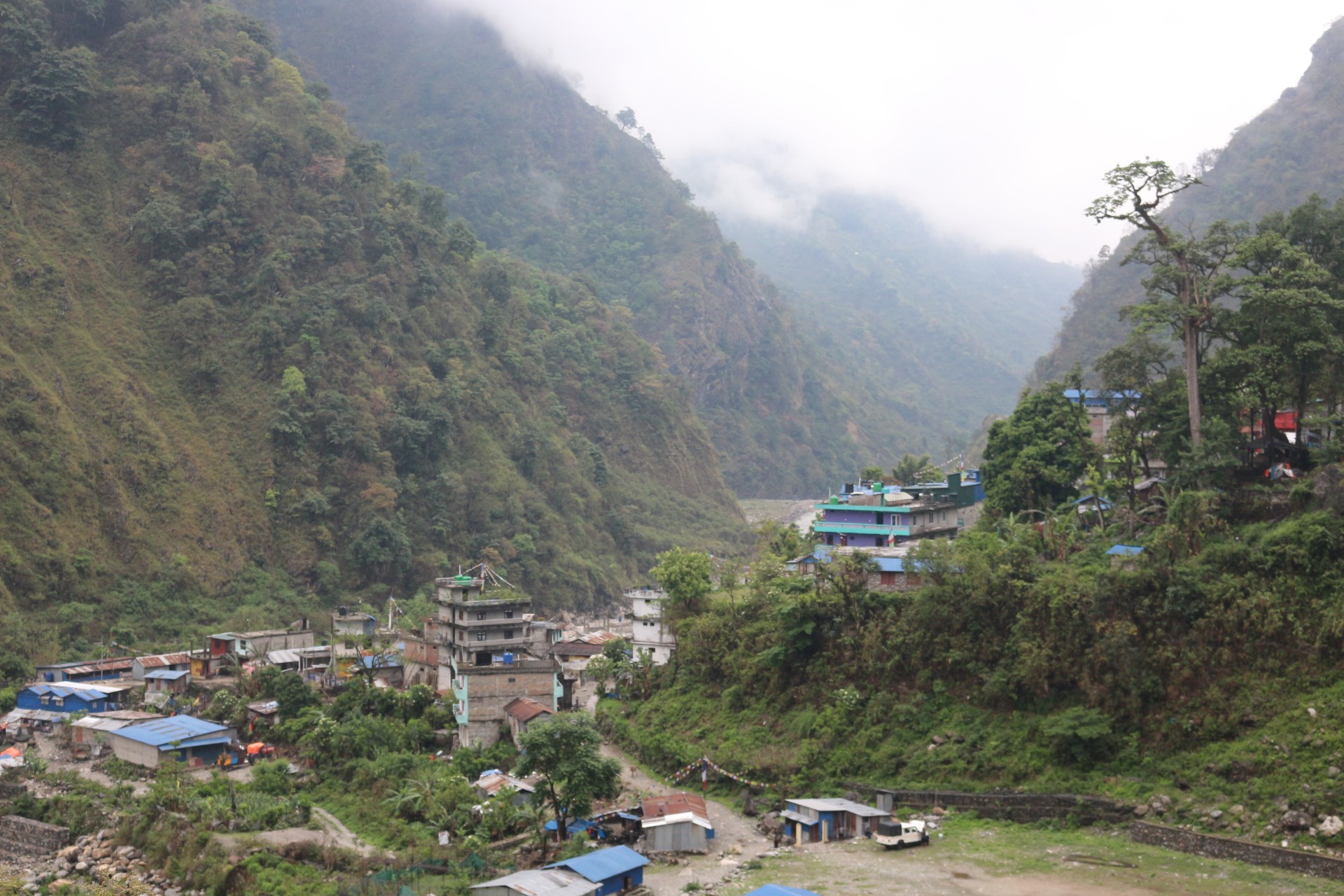 Low-altitude Himalayan foothills and valleys in Nepal showing lush greenery and gradual mountain ascent areas used as starting points for acclimatization during trekking.