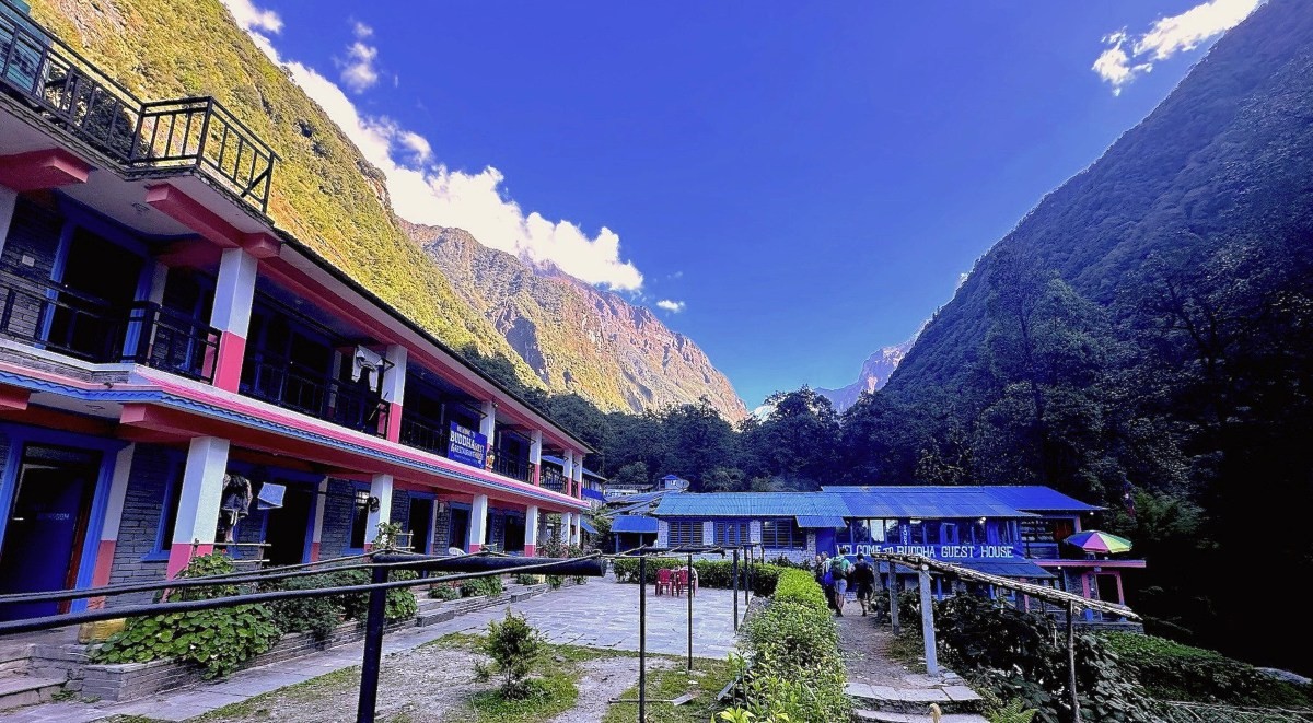 Bamboo teahouse lodges along the Annapurna Base Camp trekking route, surrounded by dense green forest and misty Himalayan valley. 