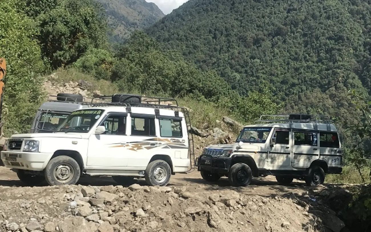 Jeep traveling toward the Mardi Himal Trek trailhead through scenic mountain roads, traditional villages, and the Himalayan landscape in Nepal