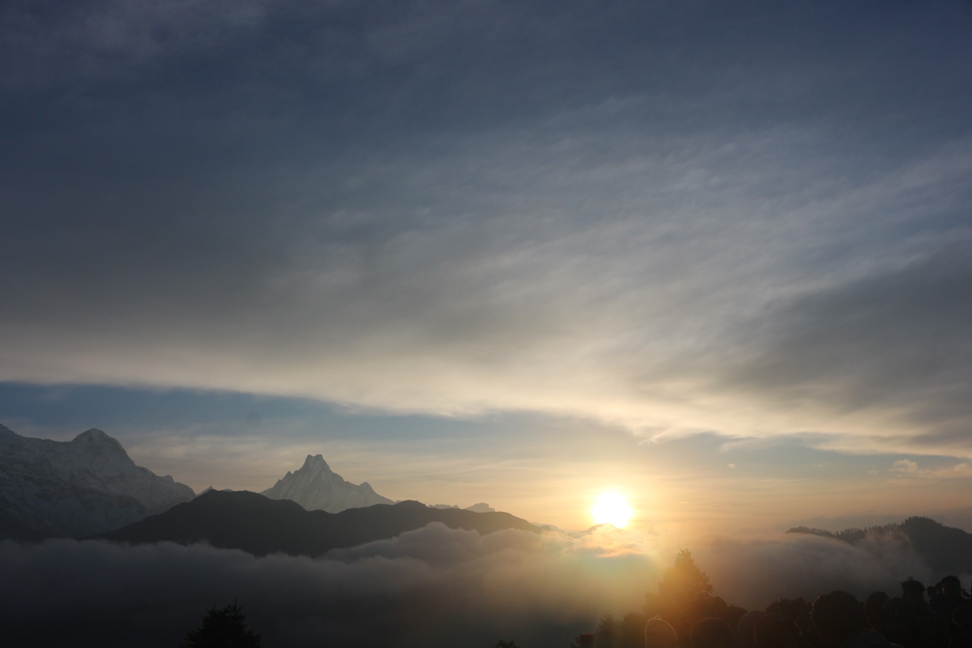 "Spectacular September sunrise over Machhapuchhre (Fishtail Mountain) from the Mardi Himal Trek in Nepal, with golden sunlight, clouds filling the valleys, and breathtaking Himalayan scenery."