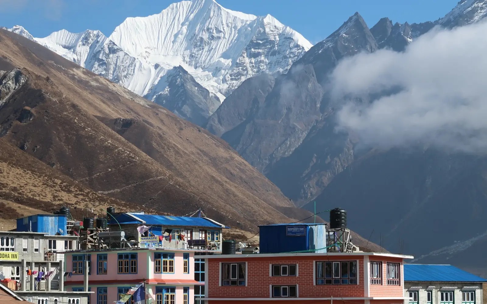 Traditional teahouse lodge in the Langtang Valley with cozy twin rooms, a warm dining hall, and stunning Himalayan mountain views during the busy October trekking season.