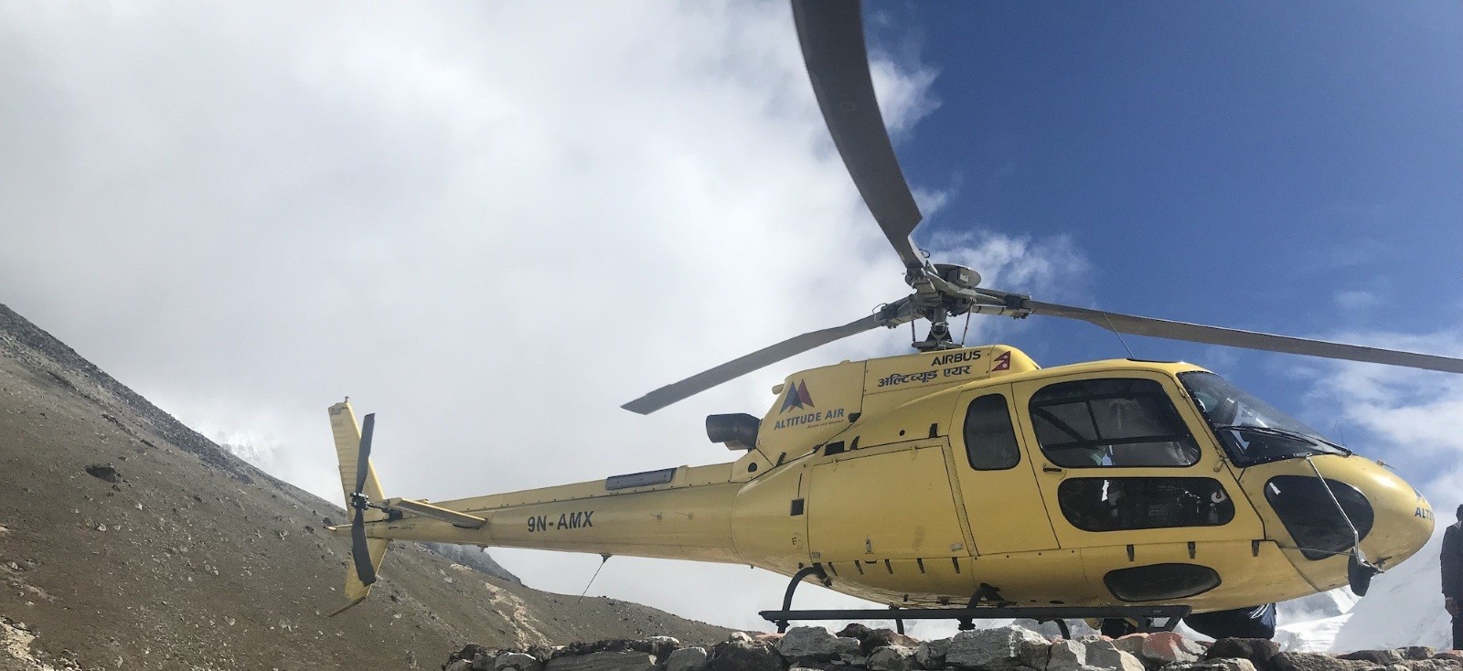 "Helicopter taking off from Gorak Shep for an Everest Base Camp helicopter return flight with Mount Everest and the Himalayan peaks in Nepal."