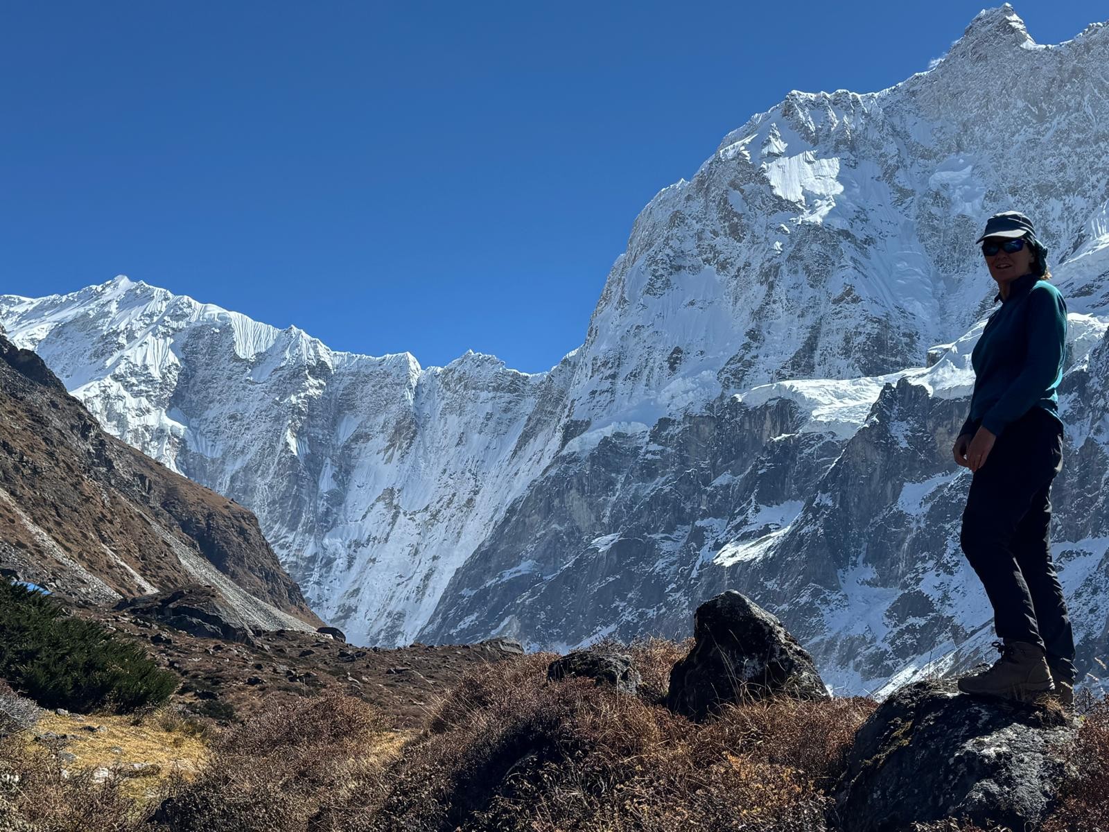 Trekker enjoying the remote Kanchenjunga Trek with towering snow-capped peaks, rugged alpine landscapes, and pristine mountain scenery in eastern Nepal.
