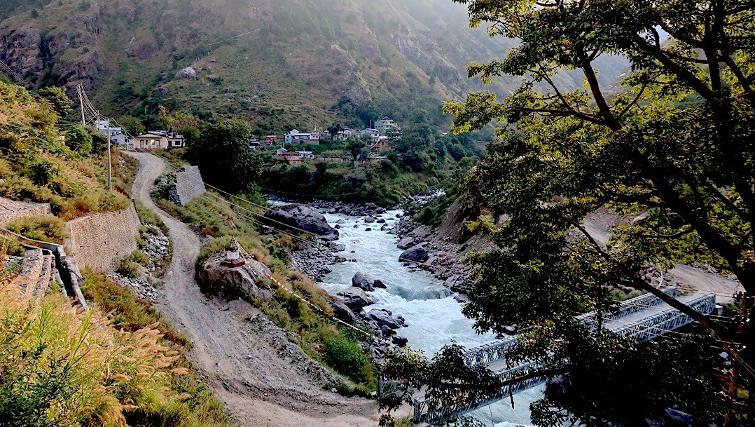 Syabrubesi village, the gateway to the Langtang Valley Trek, featuring riverside settlements, green hills, suspension bridges, and scenic Himalayan foothills in Nepal.
