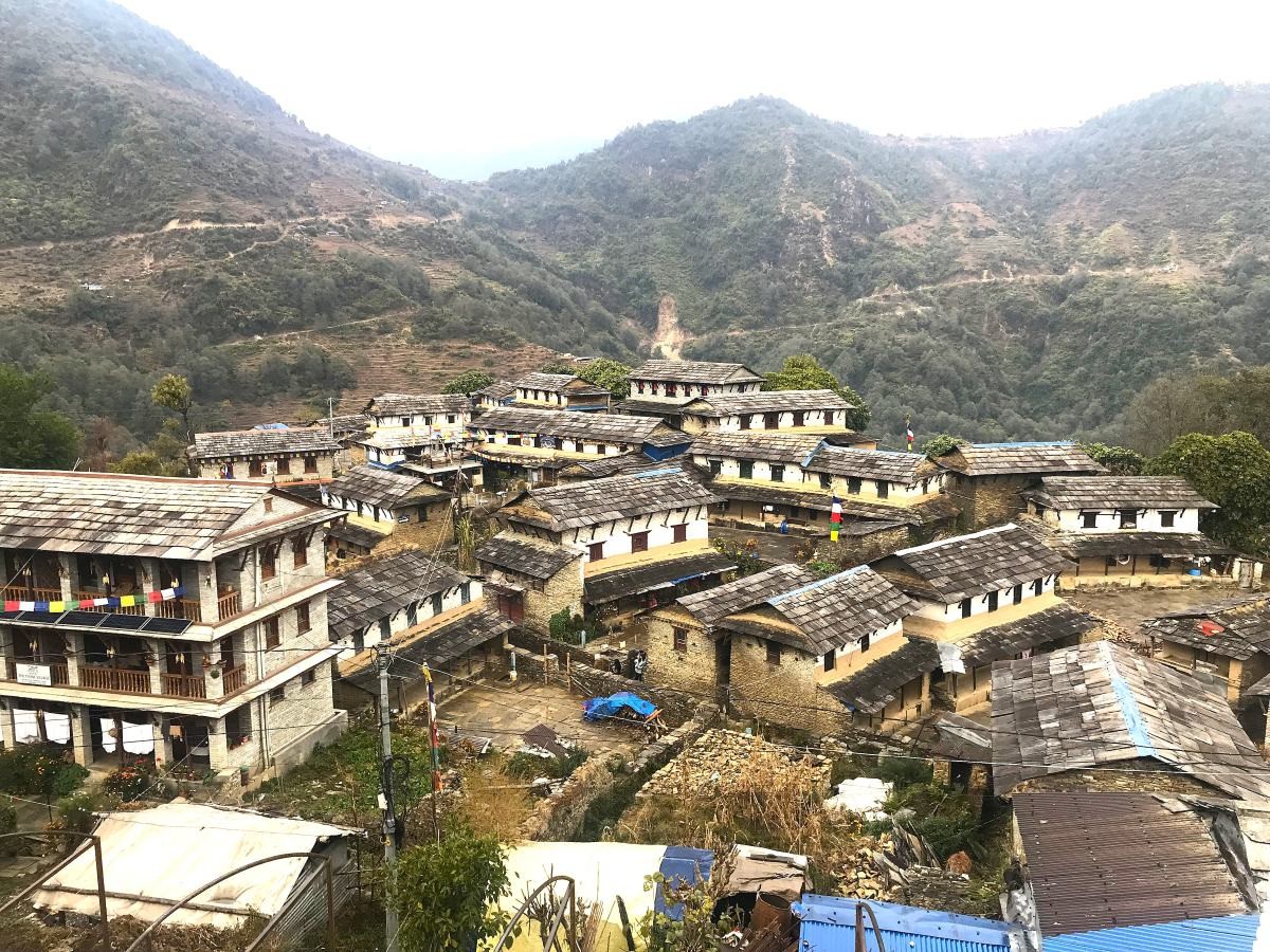 Traditional Ghandruk Village with stone houses, terraced fields, and panoramic views of Annapurna South, Hiunchuli, and Mount Machhapuchhre (Fishtail) in the Annapurna region of Nepal.