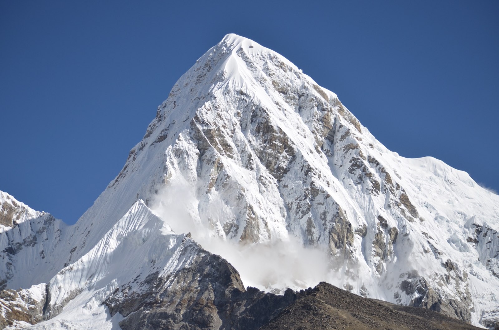 Mount Pumori (7,161 m) towering above the Khumbu Glacier with snow-covered slopes, as seen during the Everest Base Camp Trek and Everest Base Camp Helicopter Tour.