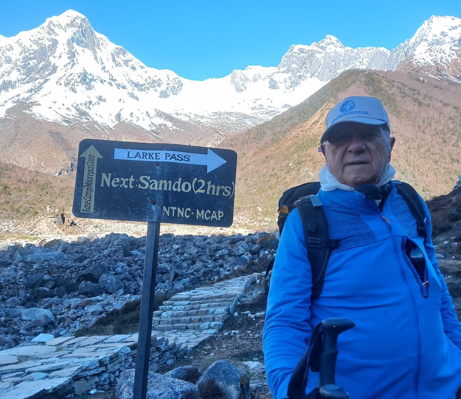 Trekkers with proper hiking gear walking toward Samdo village on the Manaslu Circuit Trek, surrounded by dramatic Himalayan mountain scenery in Nepal.