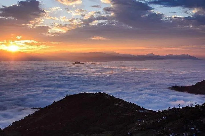 Golden sunrise over a sea of clouds with Himalayan mountains from Nagarkot, Nepal.