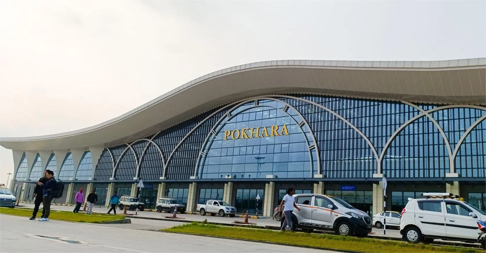 View of Pokhara Airport terminal with runway and surrounding Himalayan foothills in Pokhara, Nepal.
