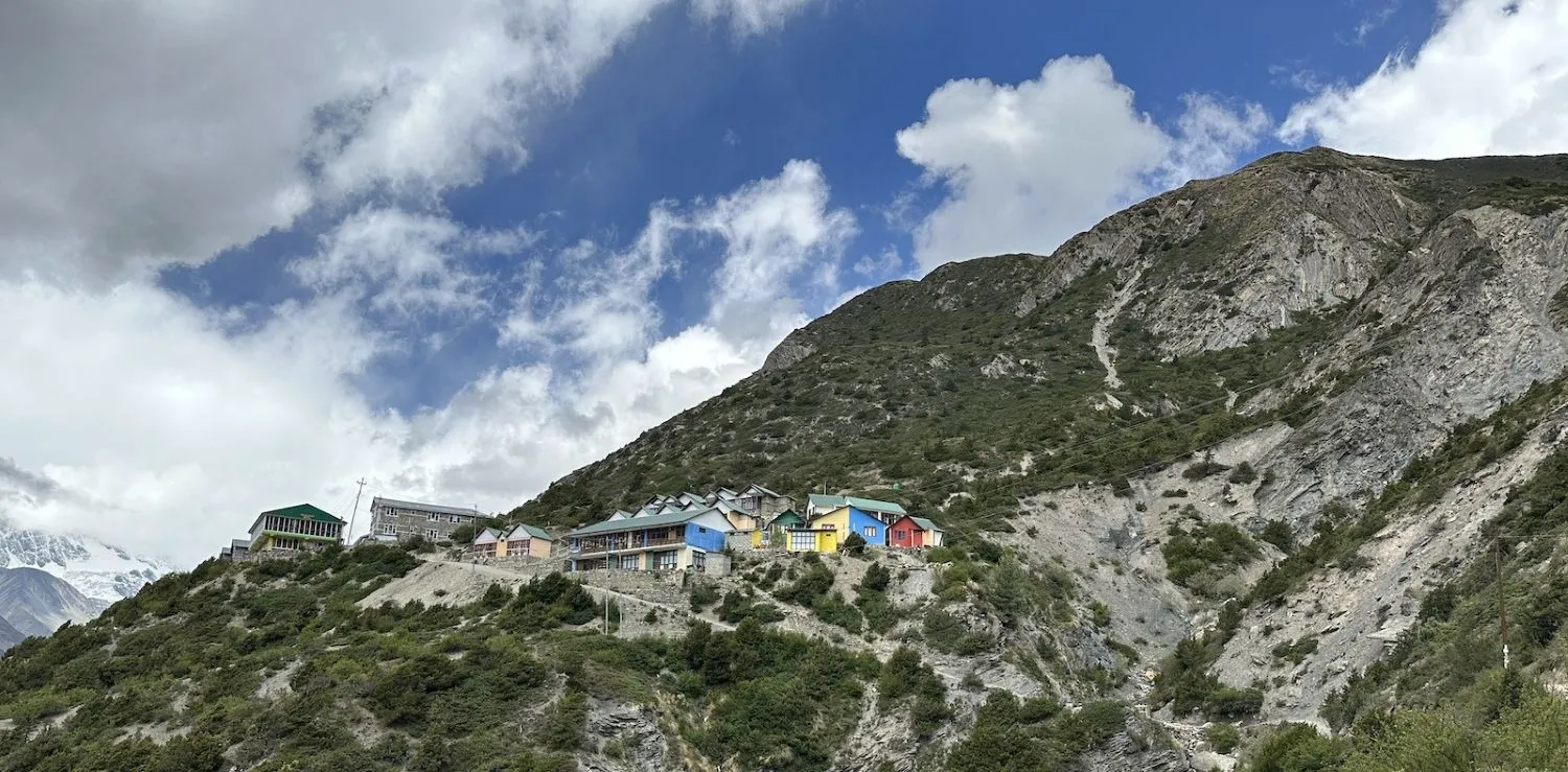Shree Kharka in the Annapurna region of Nepal, surrounded by alpine meadows, rugged Himalayan mountains, and scenic trekking trails on the route to Tilicho Lake.