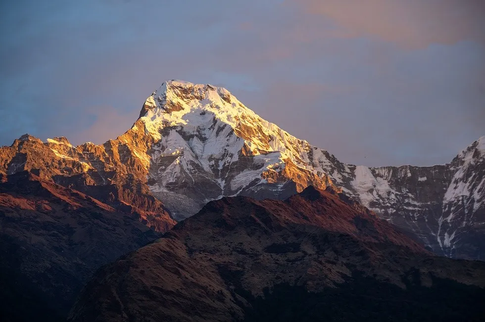 Golden sunlight illuminating Annapurna South from Poon Hill.