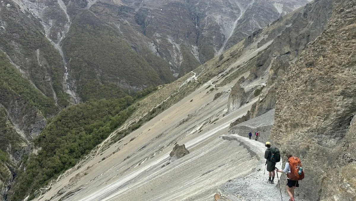Trail to Tilicho Base Camp crossing rugged landslide terrain with Himalayan mountain views in the Annapurna region of Nepal.