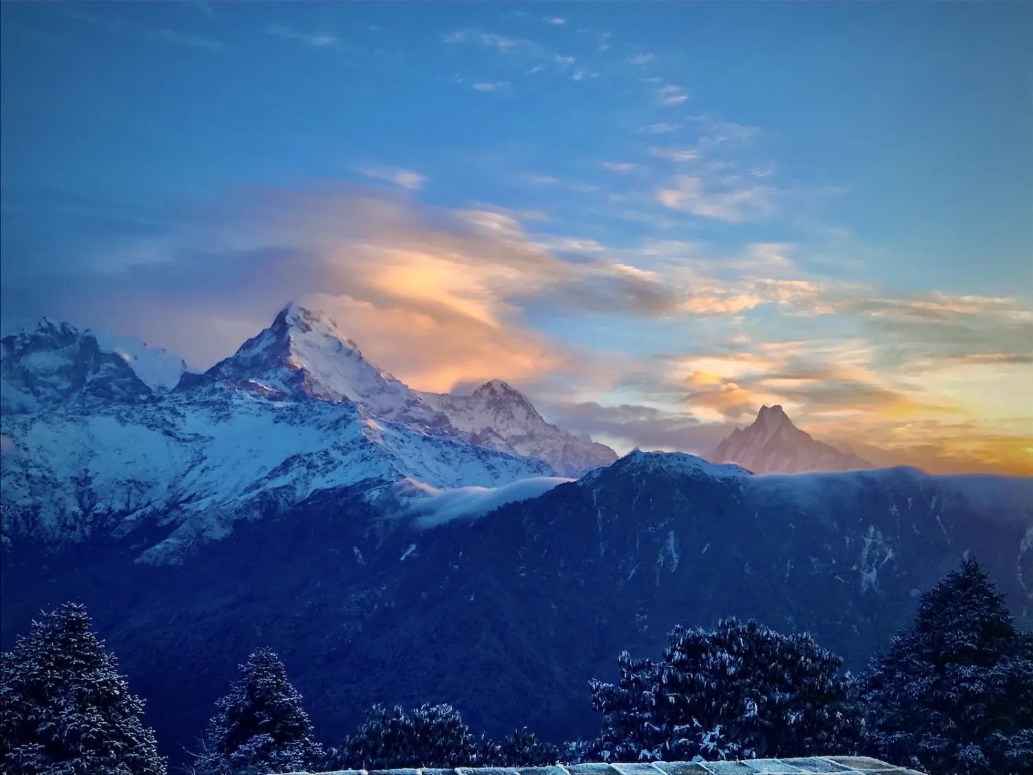 Light snowfall on the Poon Hill Trek in November with snow-dusted trails, Himalayan mountains, and trekkers enjoying clear autumn weather in Nepal.